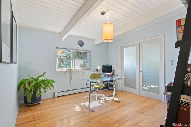 a work room with furniture and a potted plant