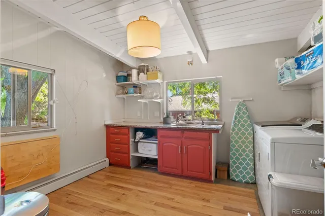 a kitchen with stainless steel appliances granite countertop a stove a sink and a wooden floors