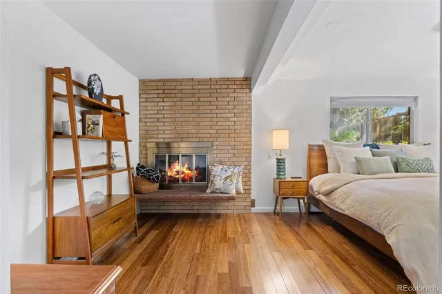 a bedroom with furniture and a fireplace