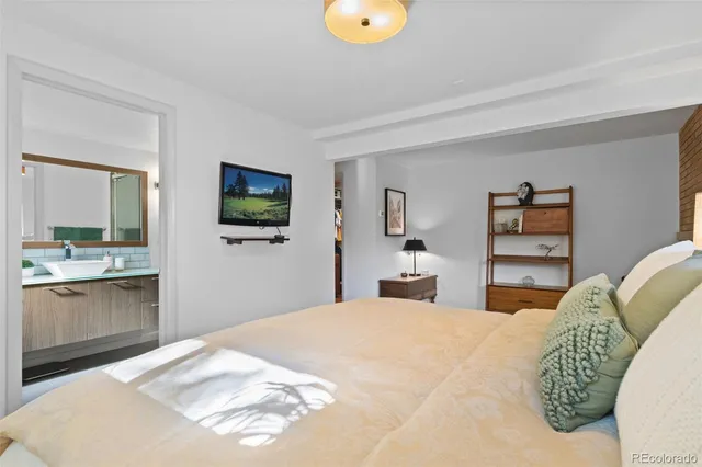 a bedroom with a bed and a flat screen tv