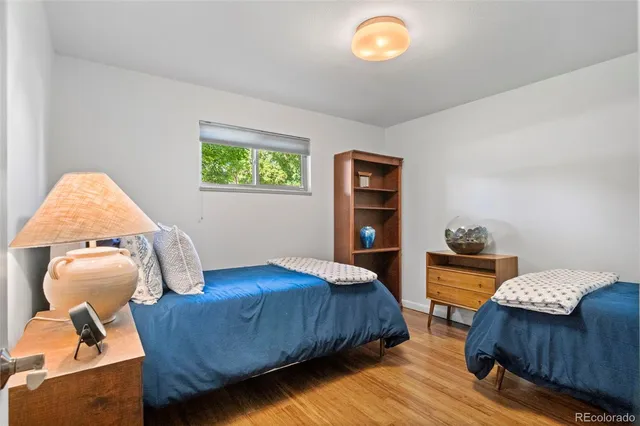 a bedroom with a bed and a lamp