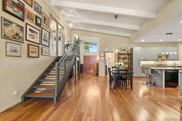 a dining room with furniture and wooden floor