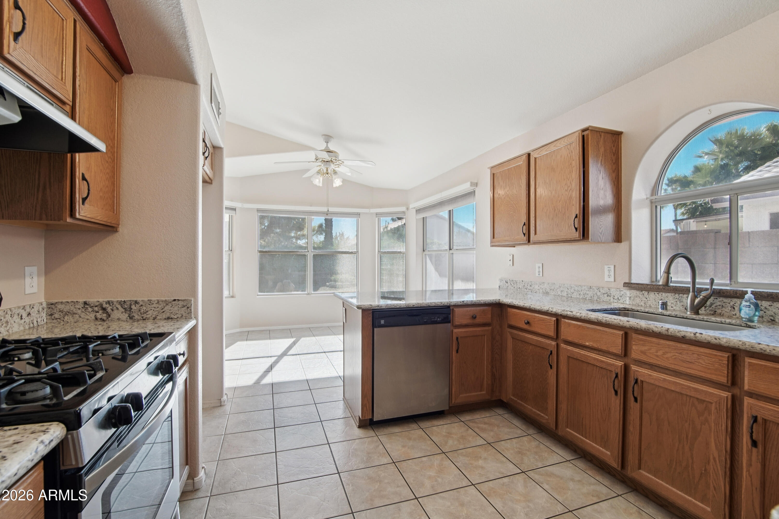 9729 West Burnett Road Peoria, AZ 85382 - Photo 10 of 29 a kitchen with a sink stove and cabinets