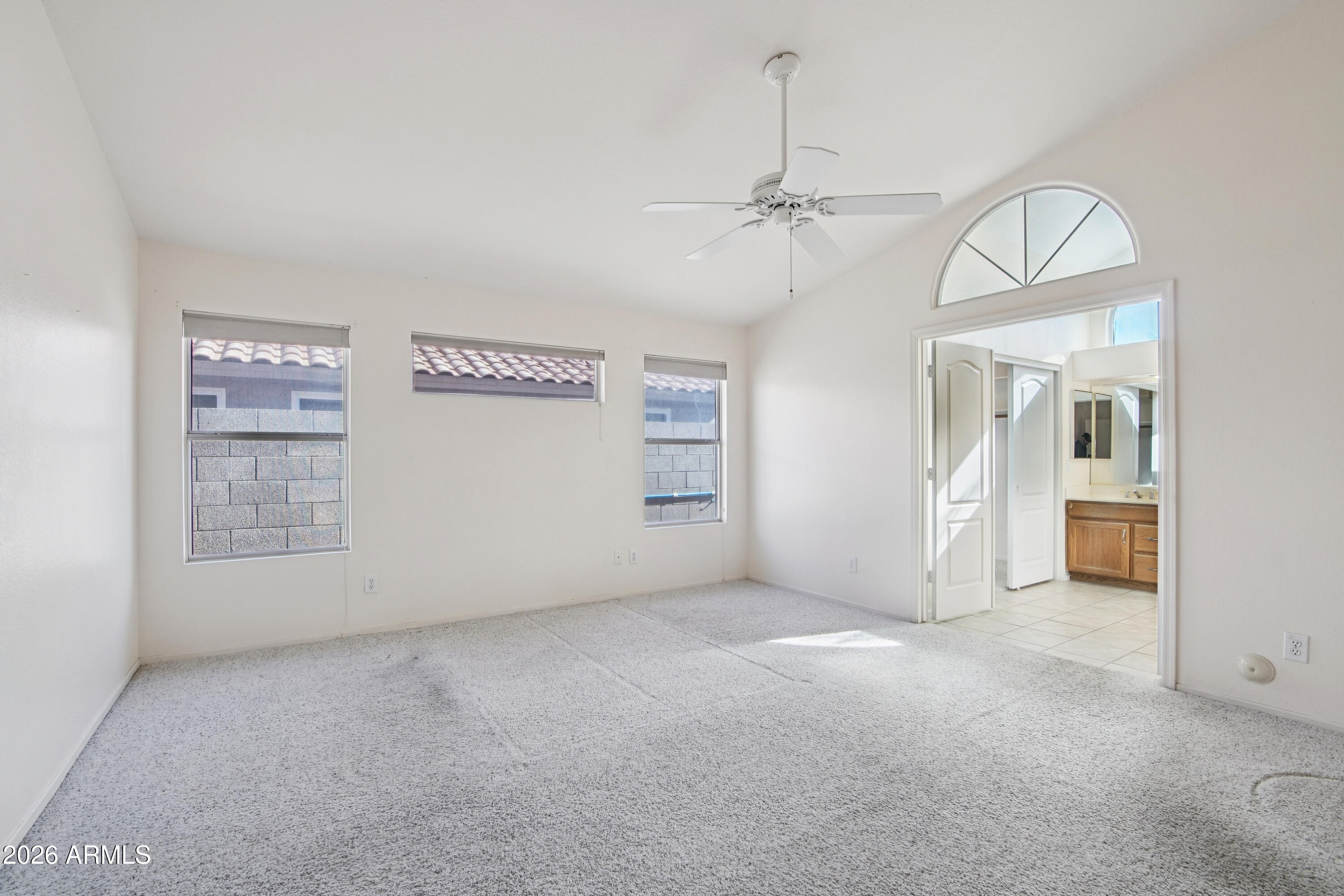 9729 West Burnett Road Peoria, AZ 85382 - Photo 12 of 29 an empty room with windows and ceiling fan