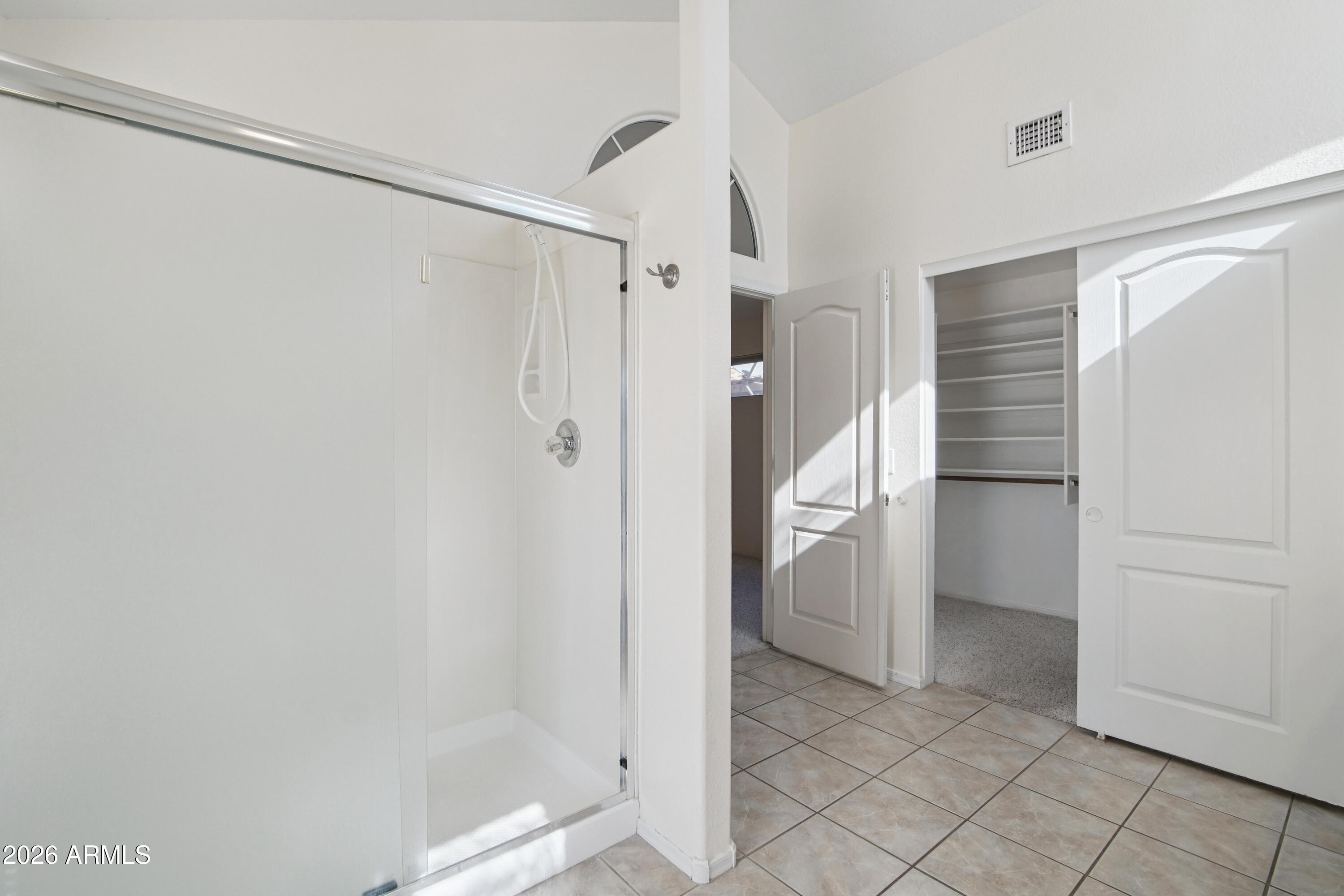 9729 West Burnett Road Peoria, AZ 85382 - Photo 16 of 29 a bathroom with a shower and a room