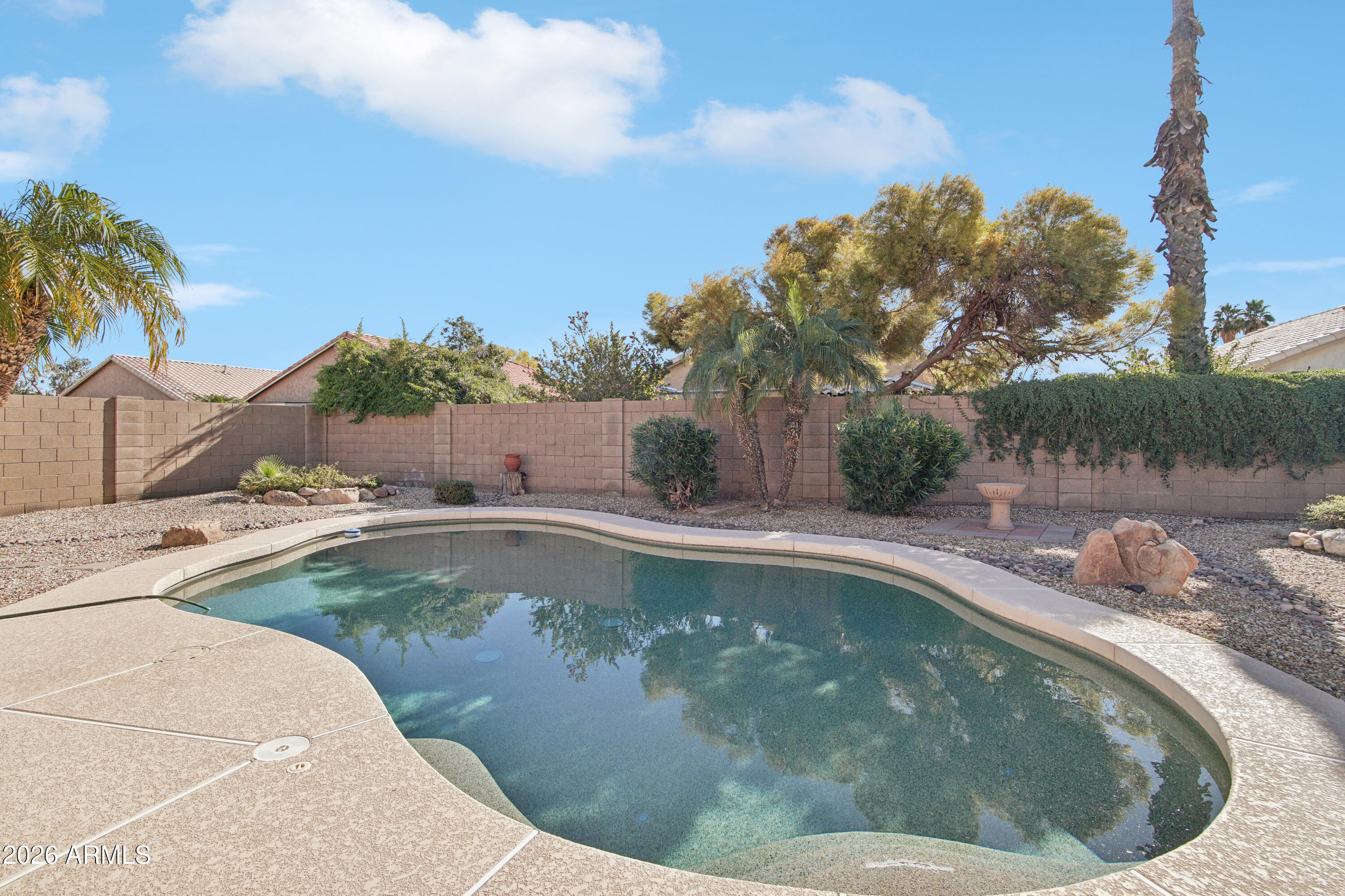 9729 West Burnett Road Peoria, AZ 85382 - Photo 25 of 29 a view of a swimming pool with a yard