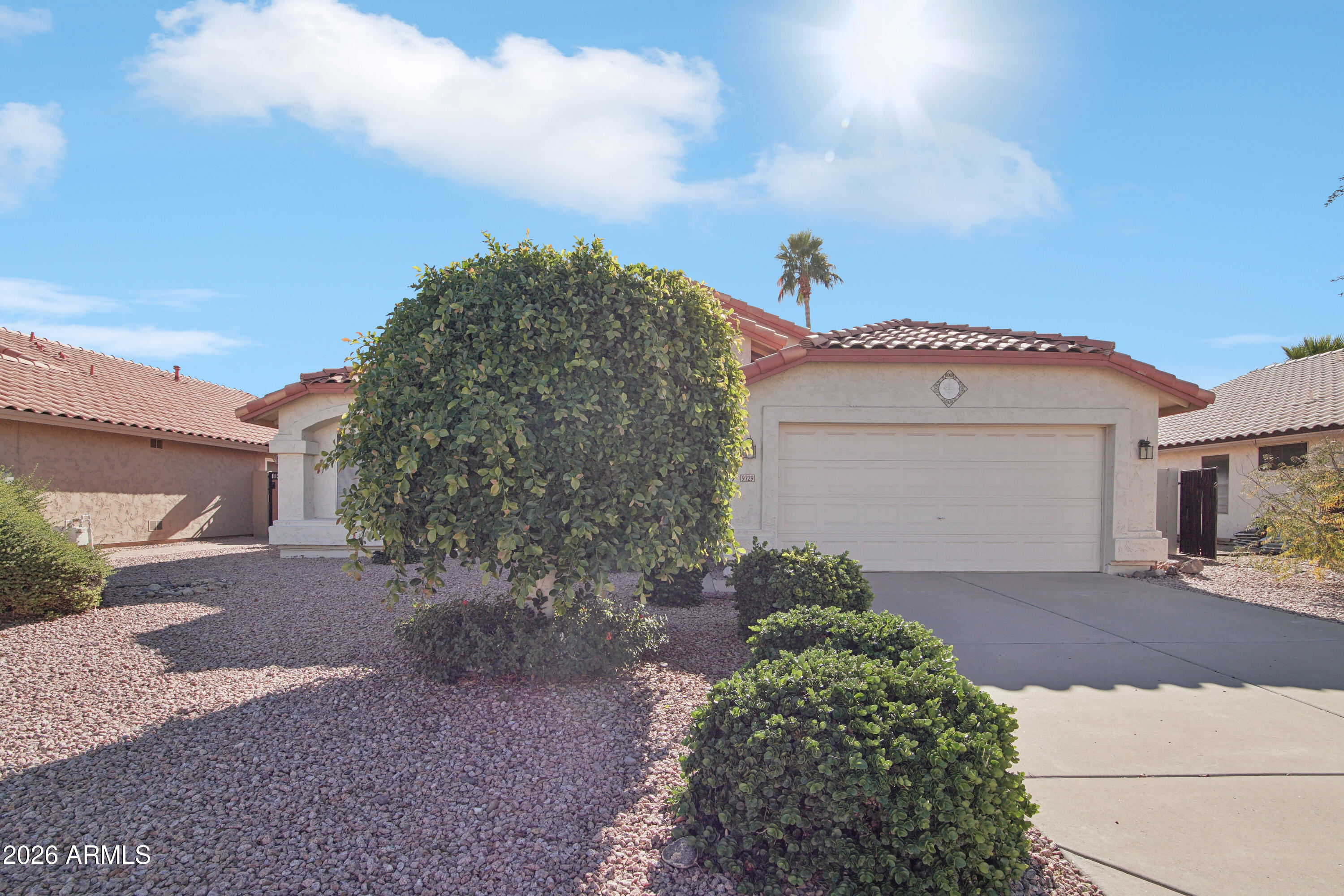 9729 West Burnett Road Peoria, AZ 85382 - Photo 2 of 29 a view of a house with a yard and garage