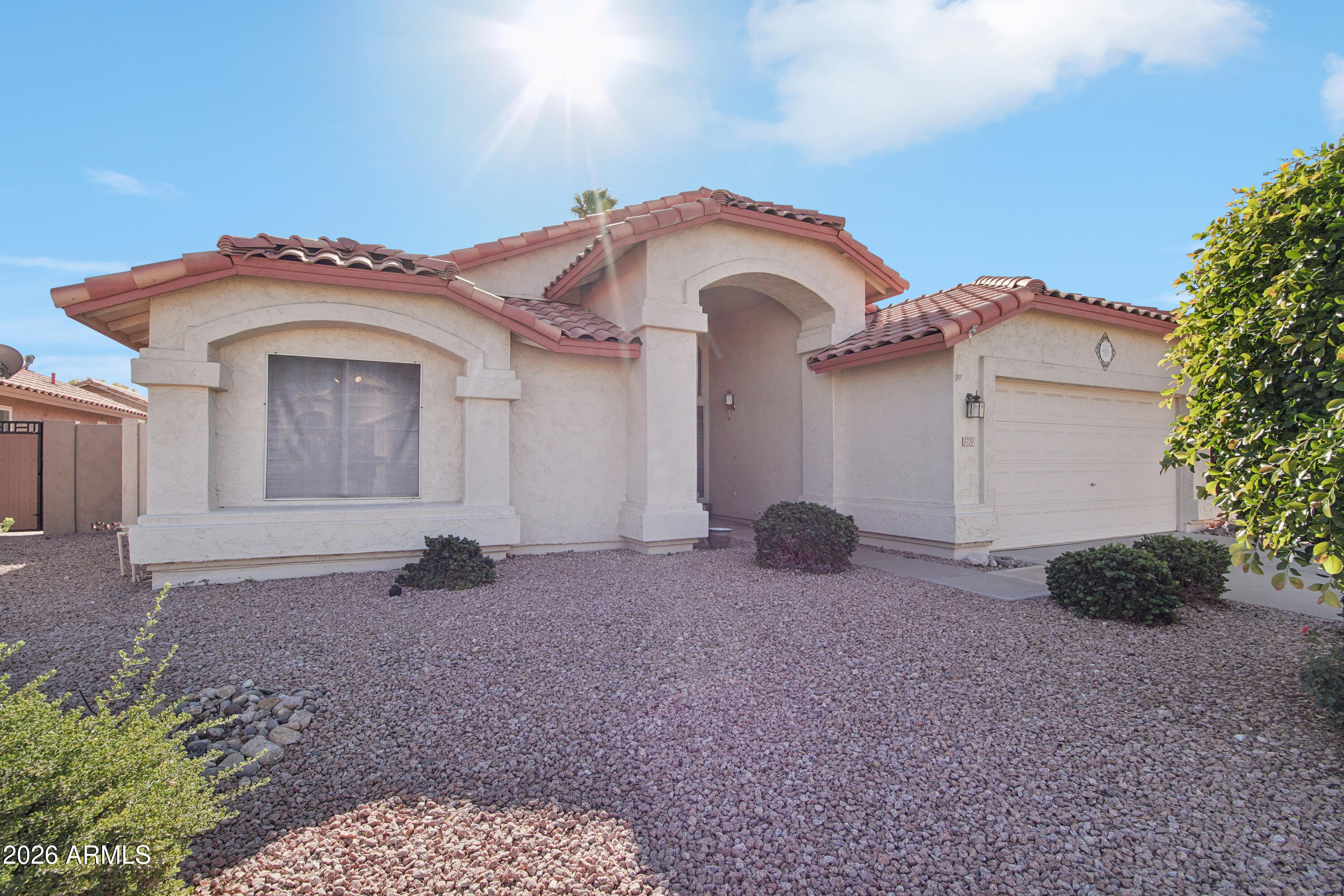 9729 West Burnett Road Peoria, AZ 85382 - Photo 3 of 29 a view of a house with a yard and plants