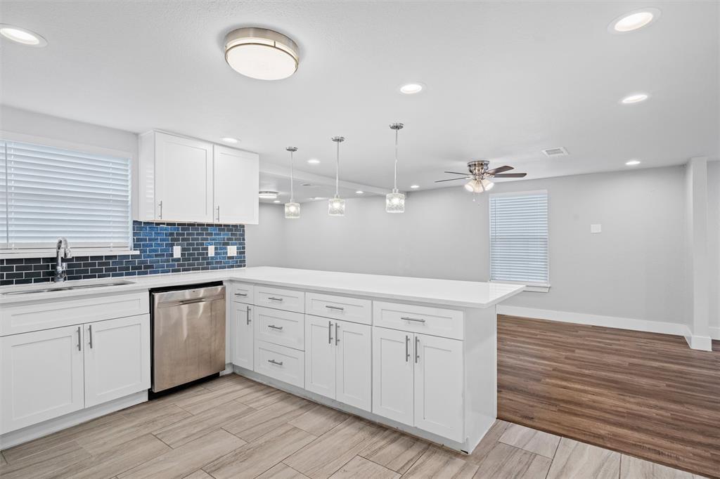 3514 Larry Street Rowlett, TX 75088 - Photo 4 of 27 a large white kitchen with a sink a stove and refrigerator