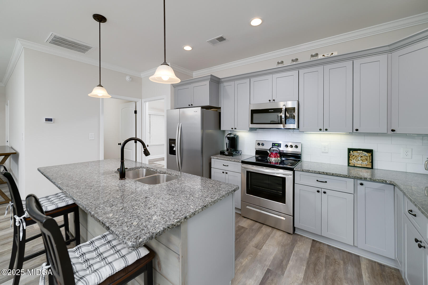 519 Barbara Court Forsyth, GA 31029 - Photo 15 of 39 a kitchen with kitchen island a counter space a sink and appliances