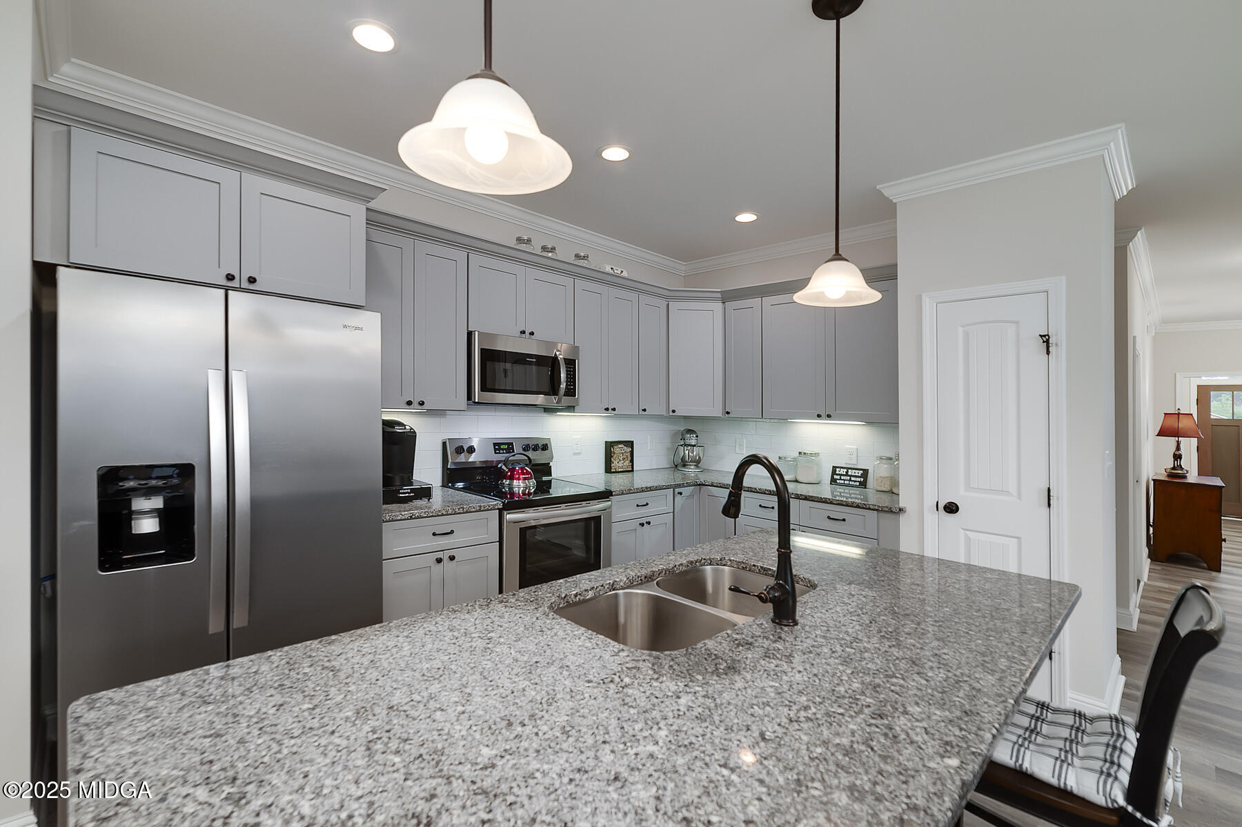 519 Barbara Court Forsyth, GA 31029 - Photo 16 of 39 a kitchen with stainless steel appliances granite countertop a sink refrigerator and microwave