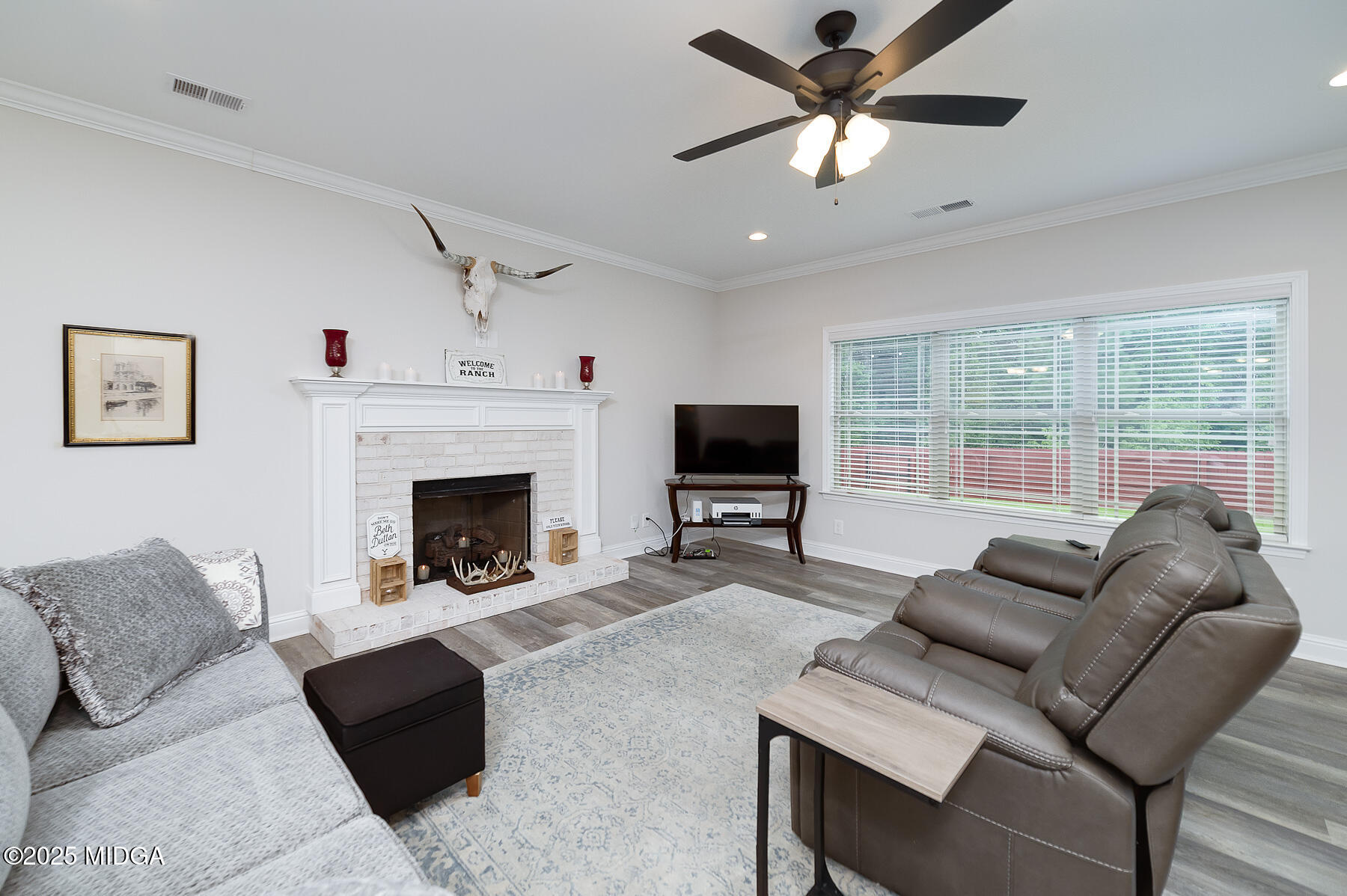 519 Barbara Court Forsyth, GA 31029 - Photo 21 of 39 a living room with furniture a flat screen tv and a large window with a flat screen tv