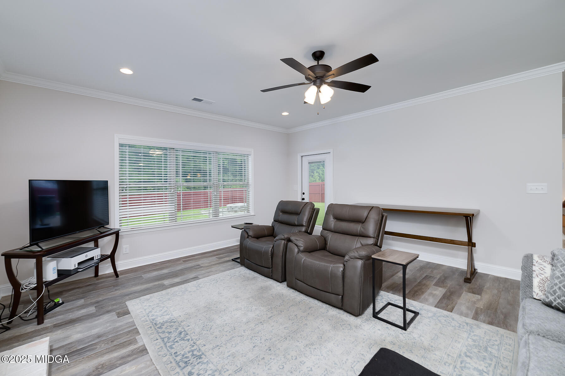 519 Barbara Court Forsyth, GA 31029 - Photo 24 of 39 a living room with furniture and a flat screen tv