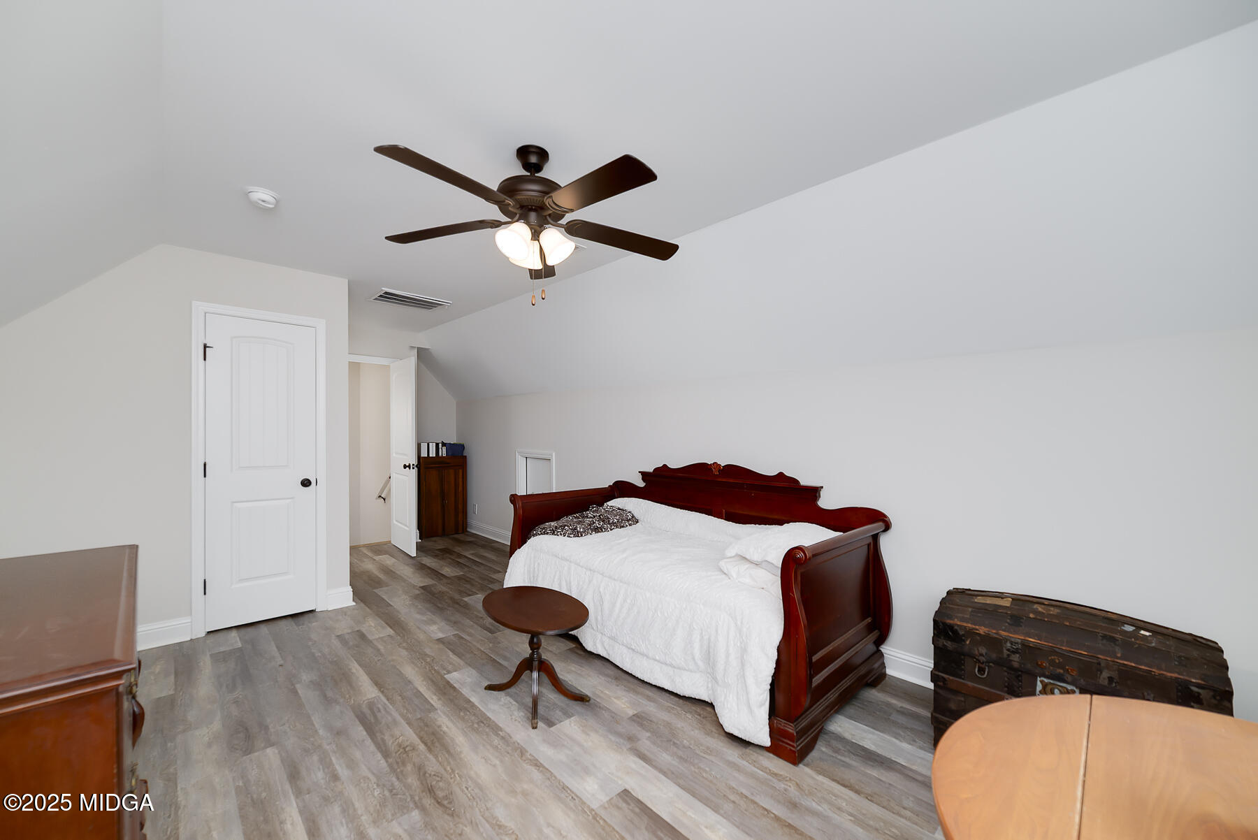 519 Barbara Court Forsyth, GA 31029 - Photo 34 of 39 a bedroom with a bed a dresser and a chandelier