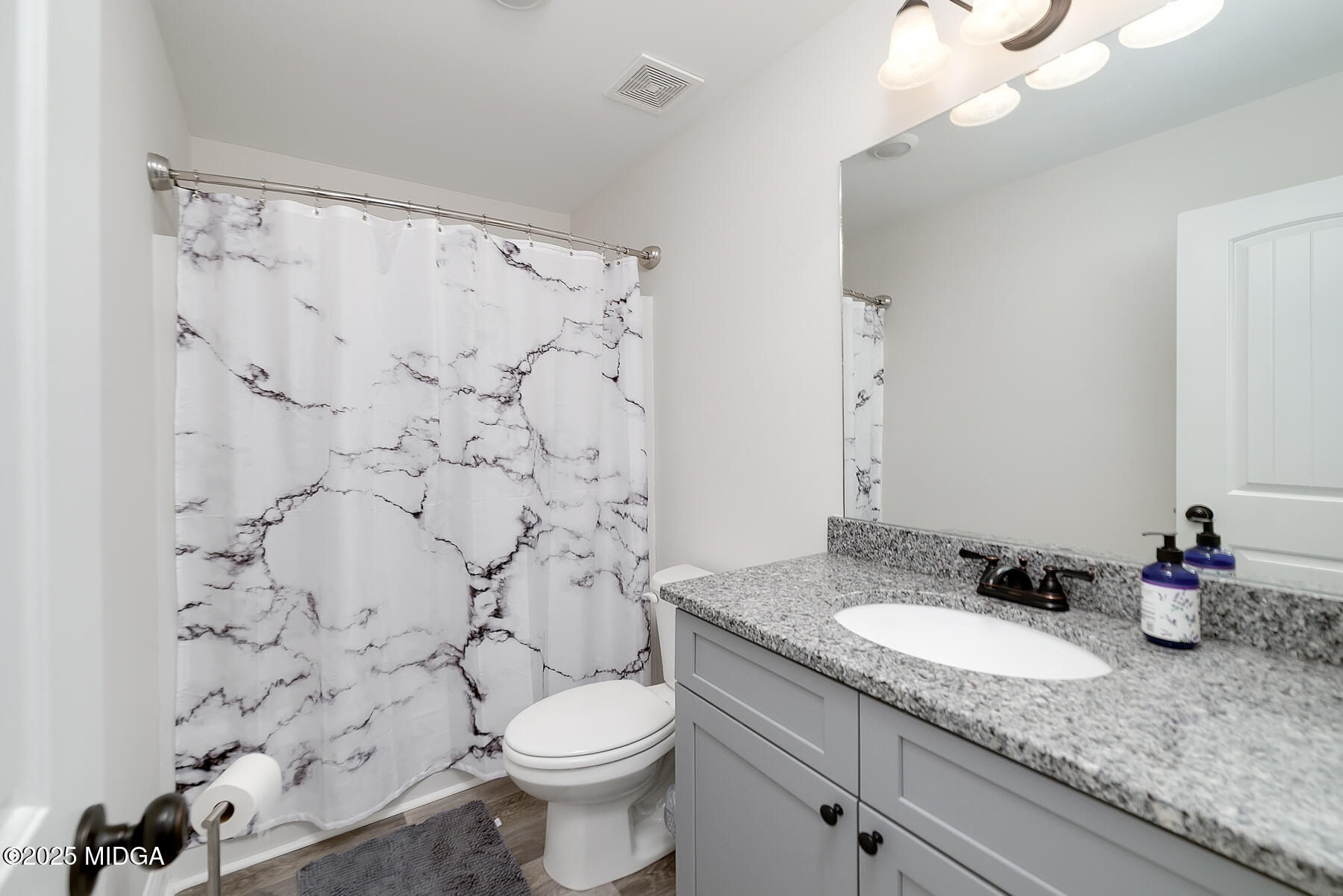 519 Barbara Court Forsyth, GA 31029 - Photo 35 of 39 a bathroom with a granite countertop sink mirror vanity and toilet