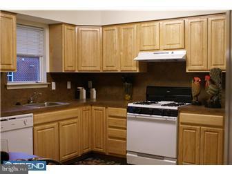 1605 West 7th Street Chester, PA 19013 - Photo 3 of 11 a kitchen with stainless steel appliances granite countertop a stove a sink and a microwave