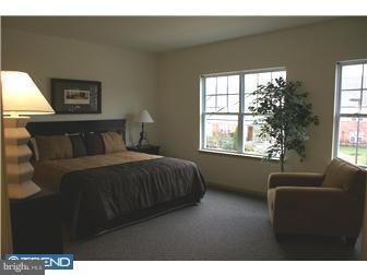 1605 West 7th Street Chester, PA 19013 - Photo 4 of 11 a bedroom with a bed and a couch next to a window
