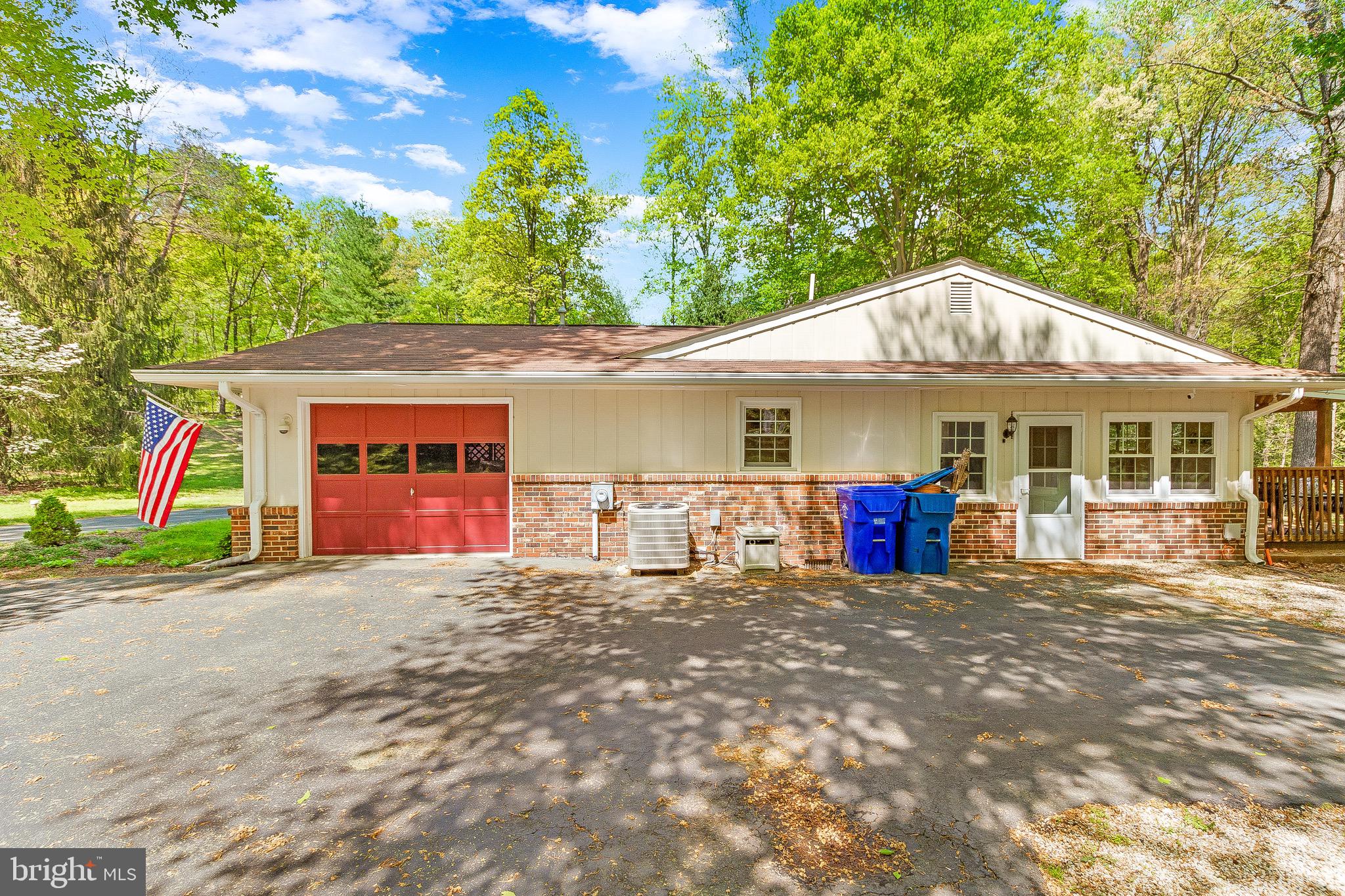 7290 Simms Landing Road Port Tobacco, MD 20677 - Photo 47 of 74 Side view of garage and home, entrance to deck