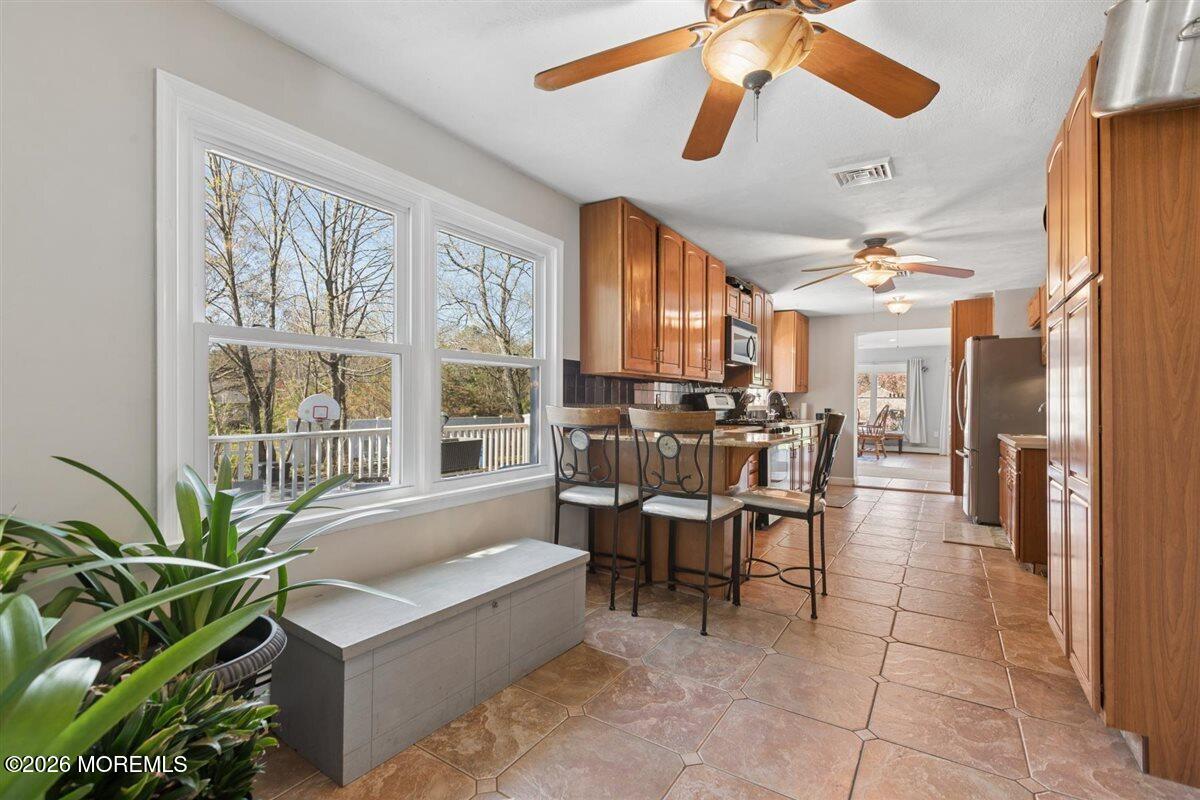 436 Cook Road Jackson, NJ 08527 - Photo 12 of 44 a dining room with chandelier fan and wooden floor