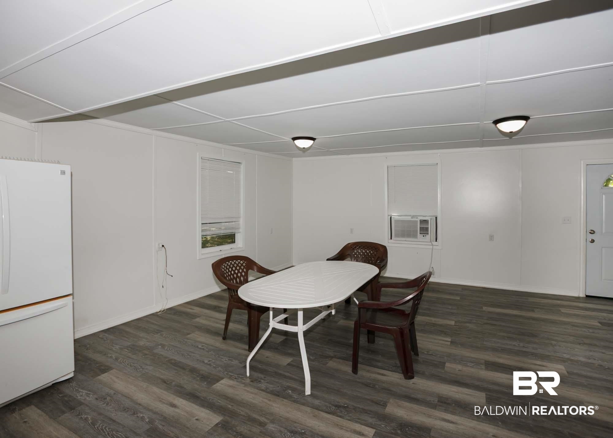 11998 Workman Avenue Foley, AL 36535 - Photo 9 of 59 Dining space with wood finished floors and baseboards