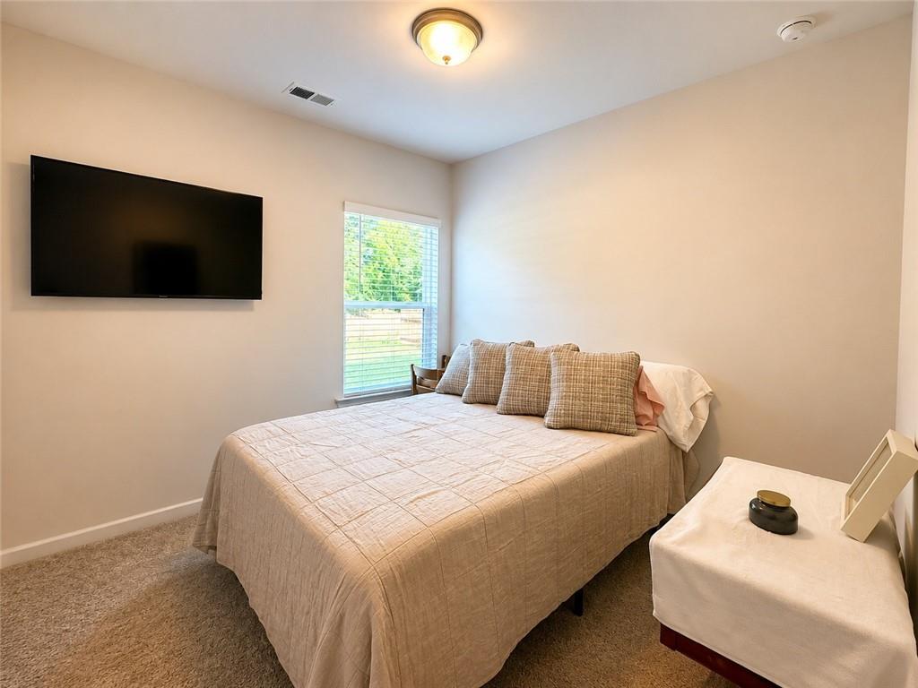 53 Bennett Way Rome, GA 30161 - Photo 16 of 42 a bedroom with a bed and a flat screen tv