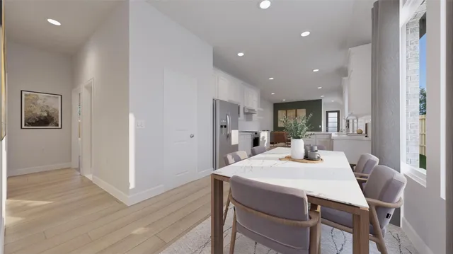 a kitchen with stainless steel appliances kitchen island granite countertop a table chairs and a refrigerator