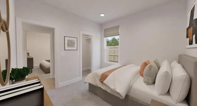 a bedroom with bed and a night stand