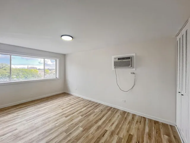 a view of a room with wooden floor and windows