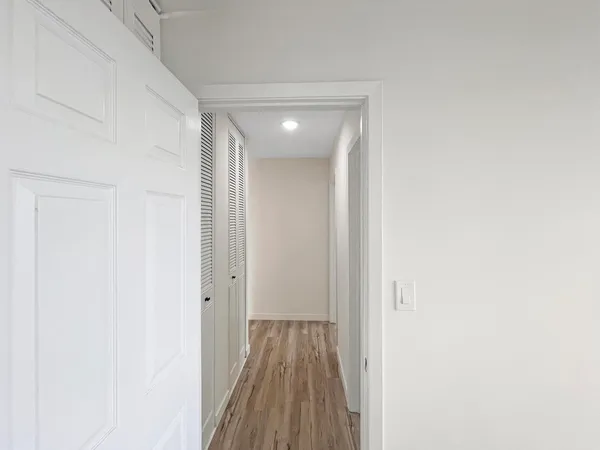 a view of hallway with wooden floor