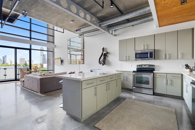 a kitchen with stainless steel appliances a refrigerator and a sink