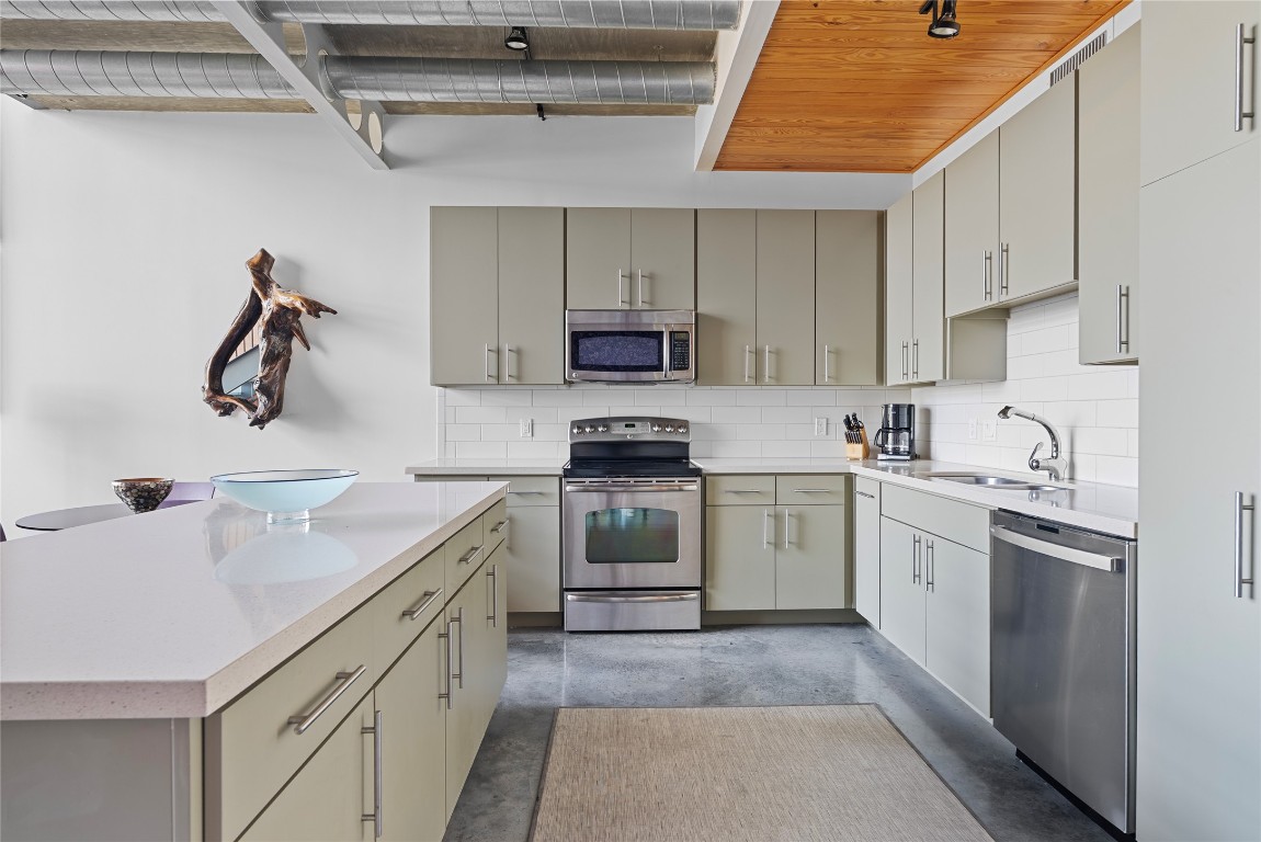 1401 Eva Street, Unit 406 Austin, TX 78704 - Photo 17 of 32 a kitchen with a sink cabinets and appliances