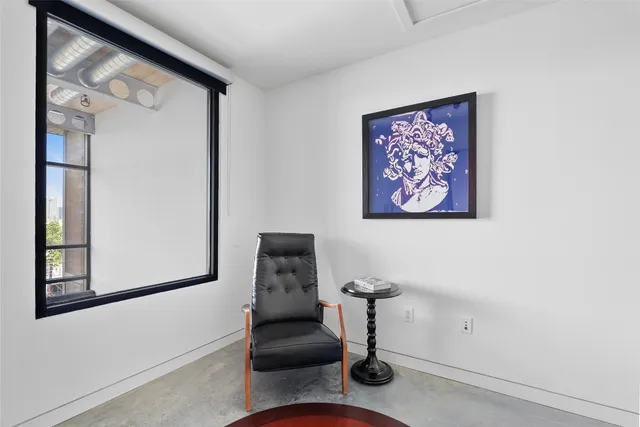 a spacious bedroom with a bed and a flat screen tv