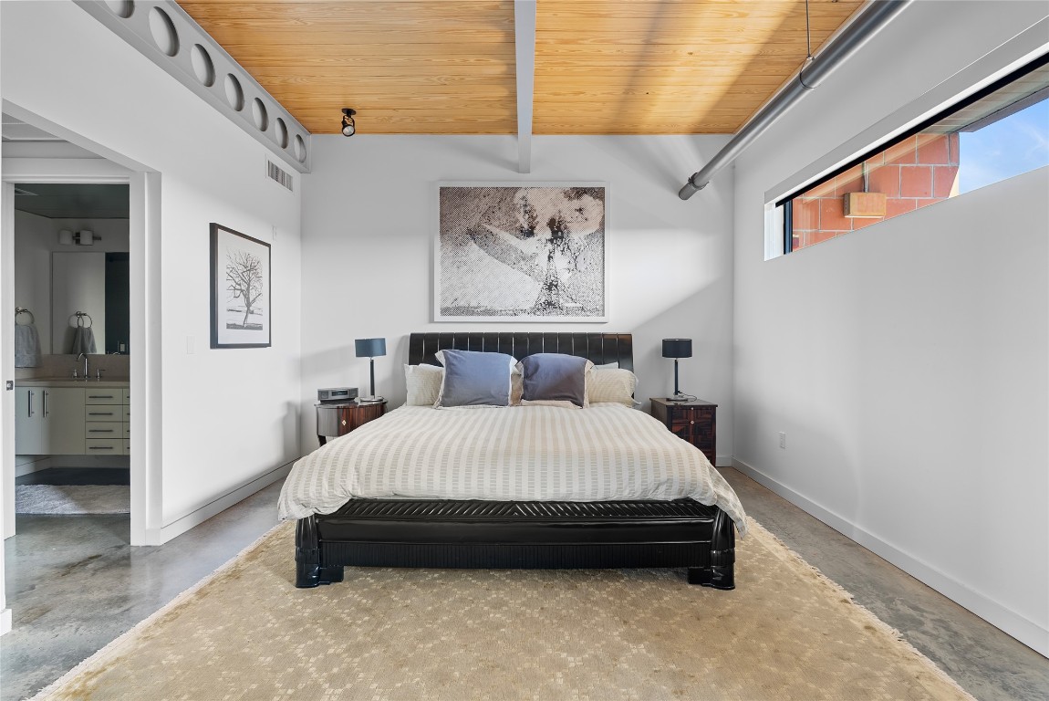 1401 Eva Street, Unit 406 Austin, TX 78704 - Photo 24 of 32 a bedroom with a bed and painting on the wall