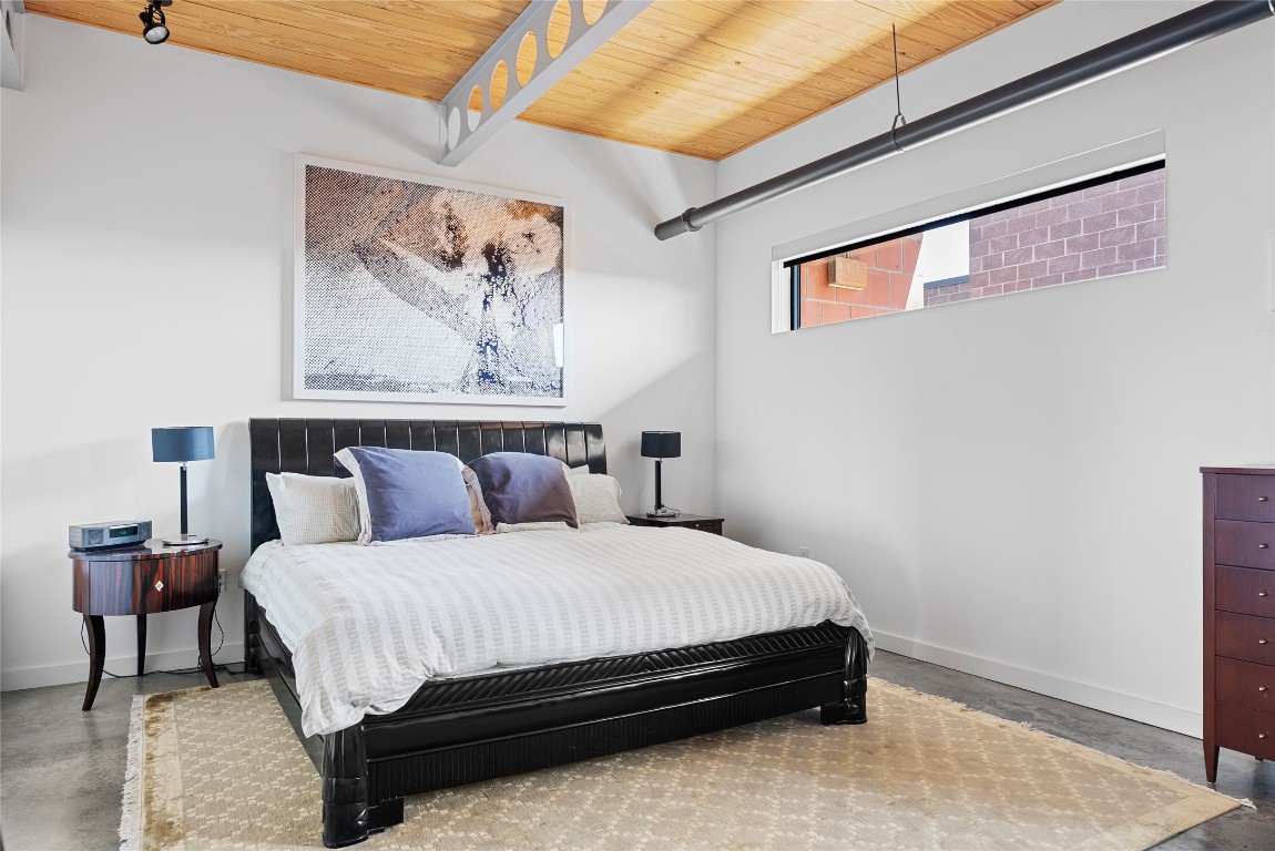 1401 Eva Street, Unit 406 Austin, TX 78704 - Photo 25 of 32 a bedroom with a bed and wall painting