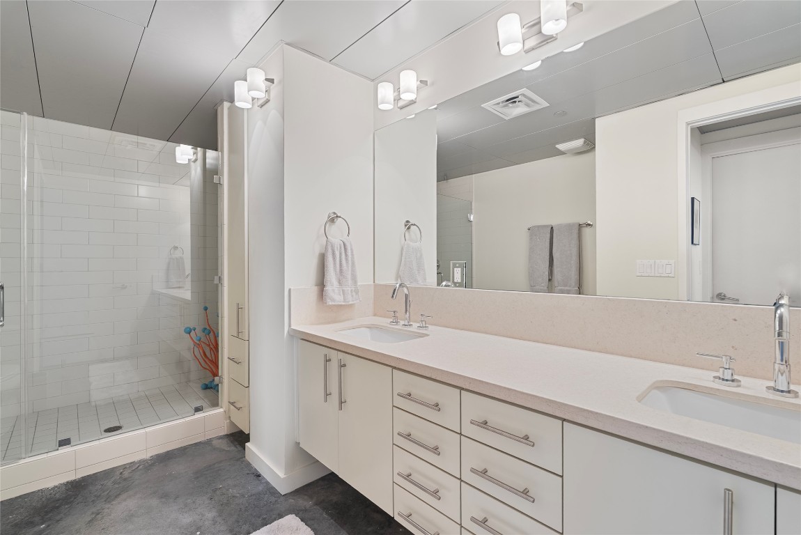 1401 Eva Street, Unit 406 Austin, TX 78704 - Photo 28 of 32 a bathroom with a shower sink and mirror