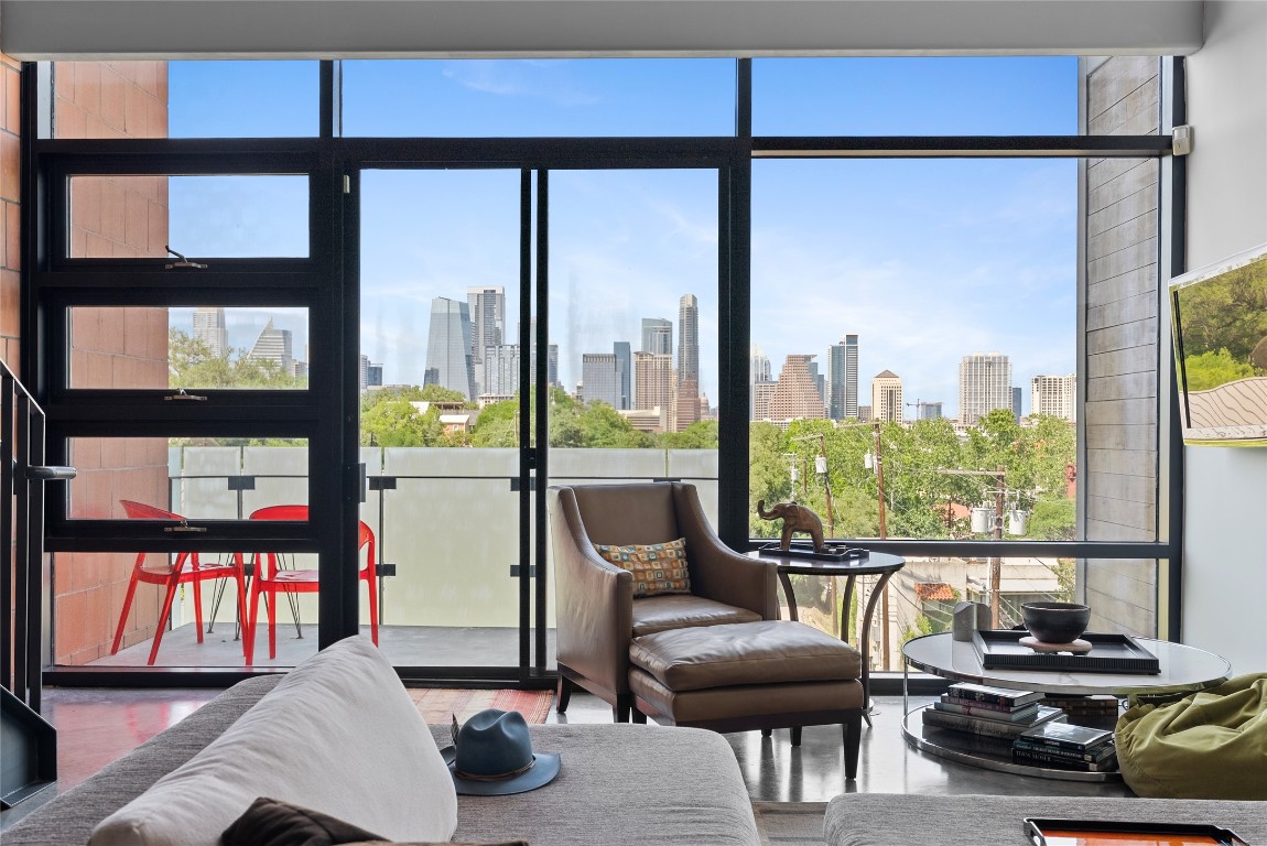 1401 Eva Street, Unit 406 Austin, TX 78704 - Photo 3 of 32 a living room with furniture and a floor to ceiling window