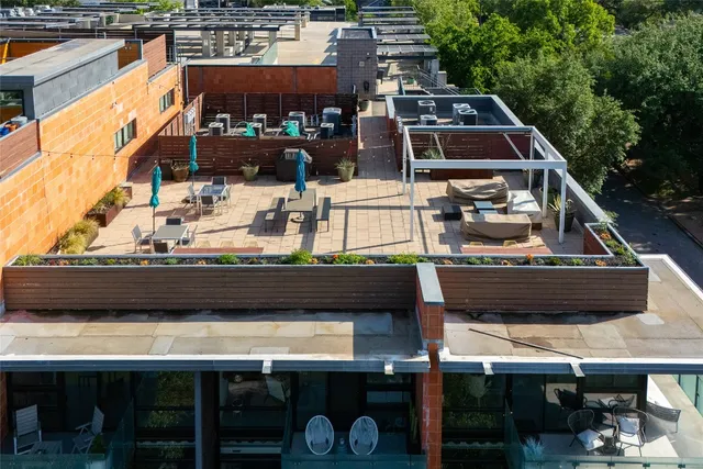 a roof deck with a chair and a fireplace