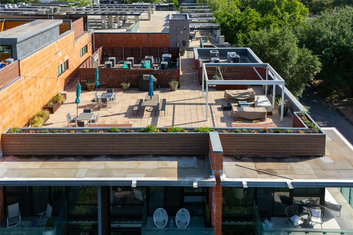1401 Eva Street, Unit 406 Austin, TX 78704 - Photo 4 of 32 a roof deck with a chair and a fireplace