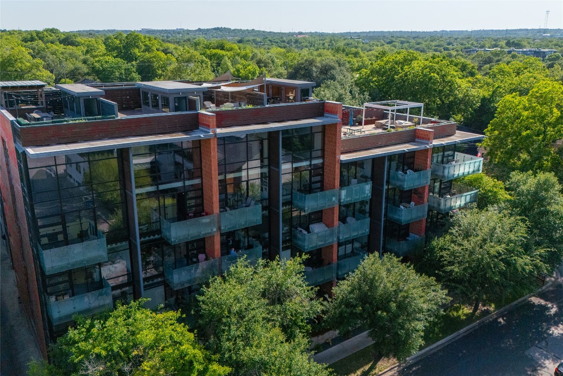 1401 Eva Street, Unit 406 Austin, TX 78704 - Photo 6 of 32 a view of a chairs and table in the balcony