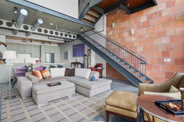 a view of a hallway to a livingroom with furniture and wooden floor