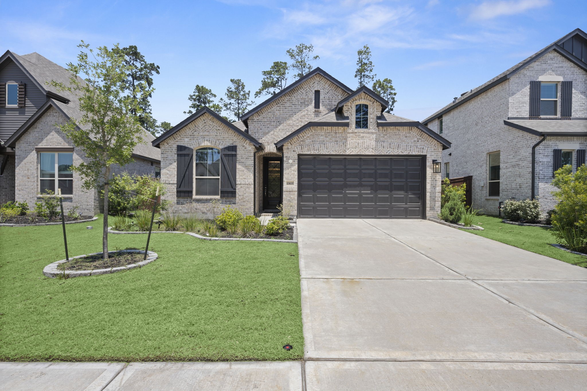 13035 Wandering Rdg Lane Conroe, TX 77302 - Photo 1 of 28 a front view of a house with a yard and garage