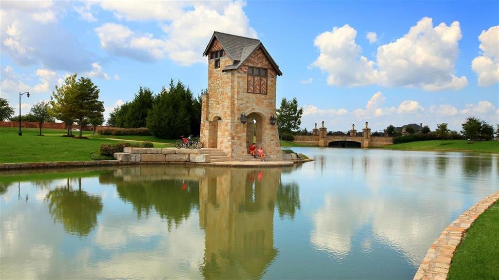 2615 Beckford Drive Forney, TX 75126 - Photo 12 of 16 a view of a lake with a house in the background