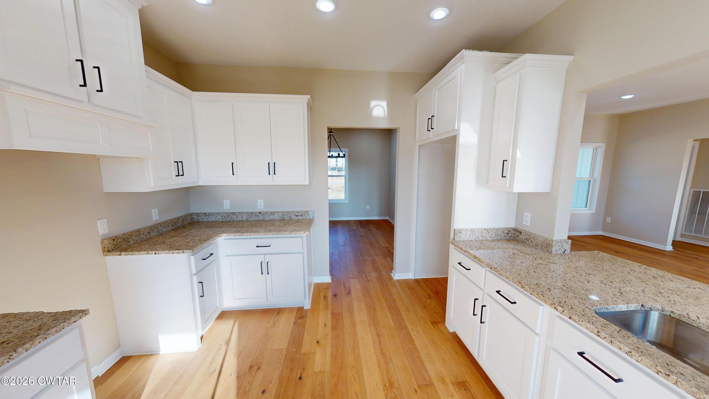 1360 Bonicord Road Dyersburg, TN 38024 - Photo 11 of 31 a kitchen with granite countertop a sink stove and refrigerator