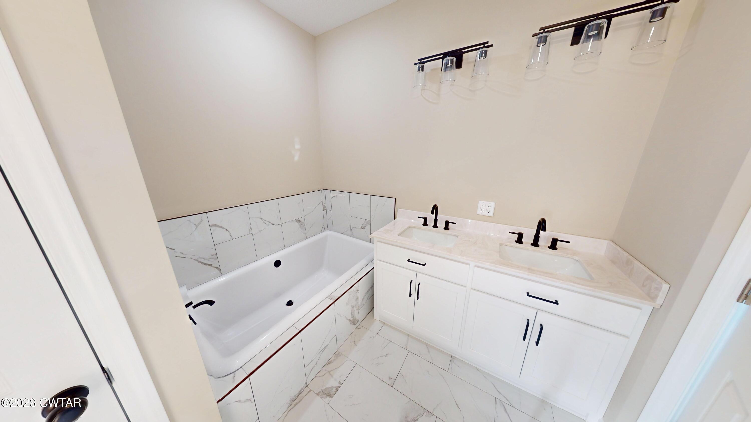 1360 Bonicord Road Dyersburg, TN 38024 - Photo 18 of 31 a bathroom with a tub sink and mirror