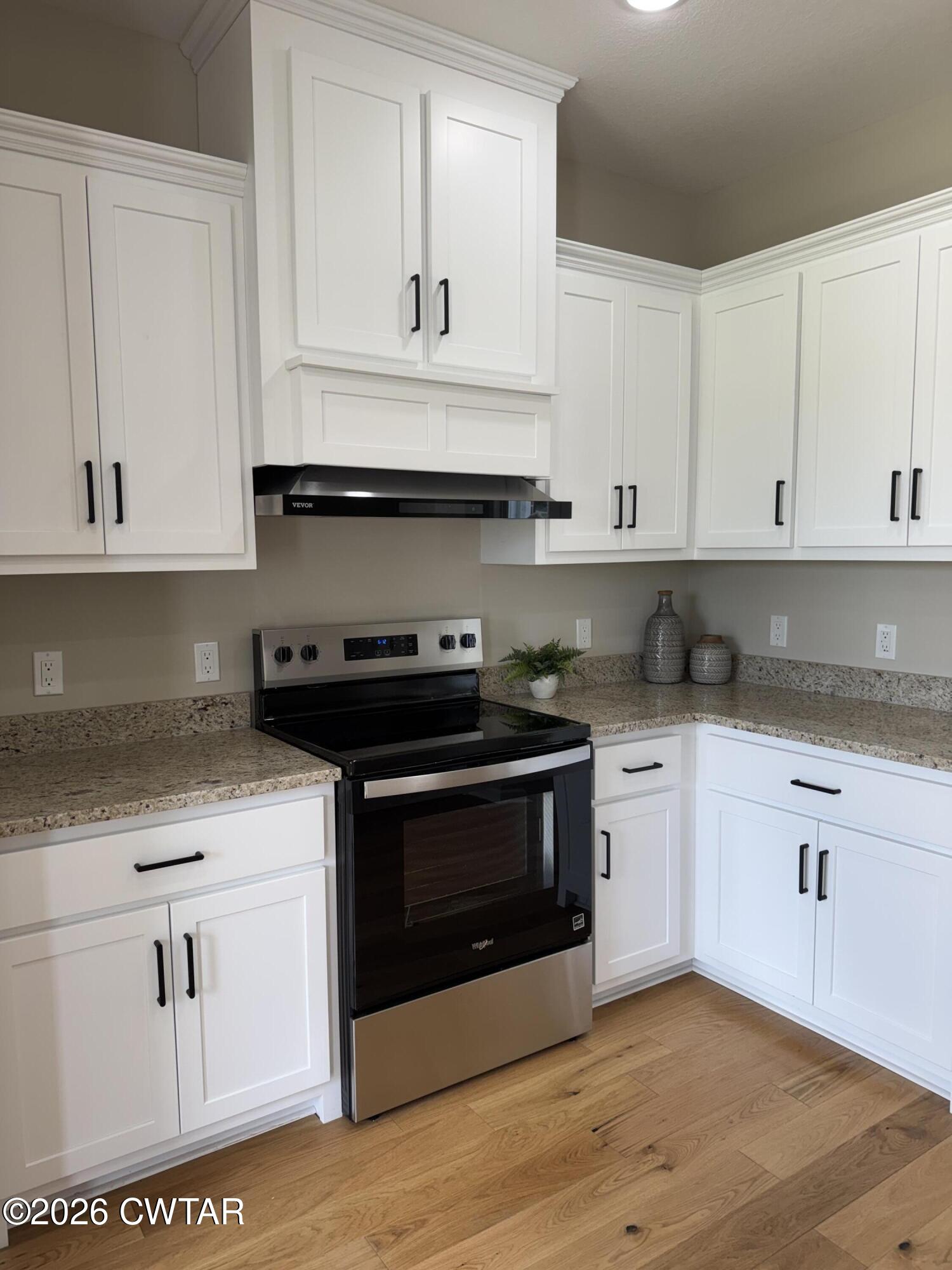 1360 Bonicord Road Dyersburg, TN 38024 - Photo 28 of 31 a kitchen with granite countertop white cabinets and appliances