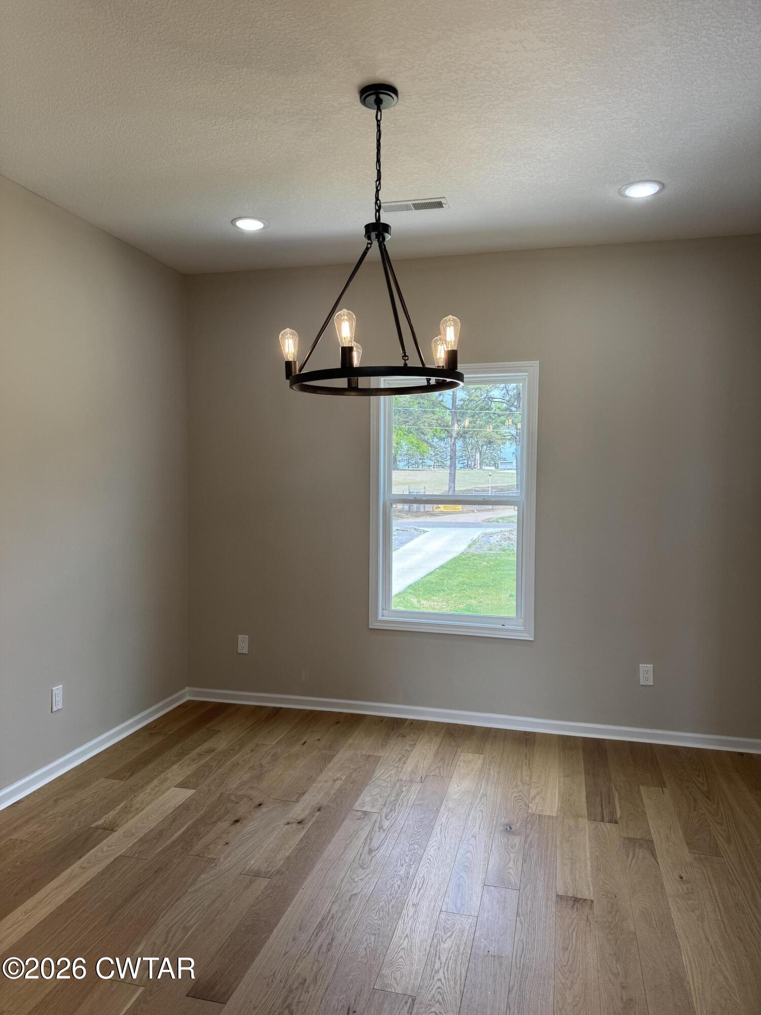 1360 Bonicord Road Dyersburg, TN 38024 - Photo 30 of 31 wooden floor in an empty room with a window
