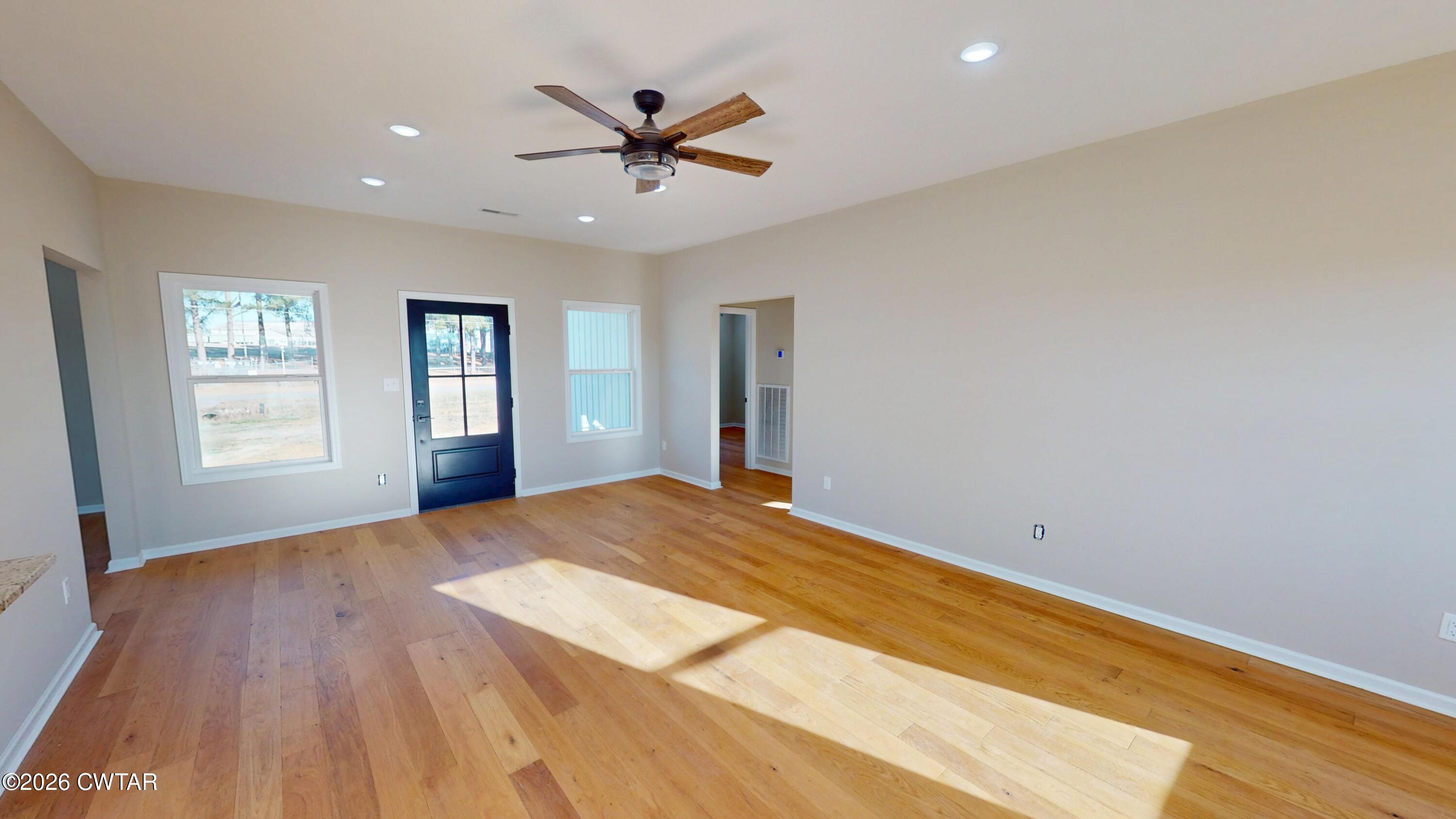 1360 Bonicord Road Dyersburg, TN 38024 - Photo 5 of 31 a view of empty room with wooden floor and window