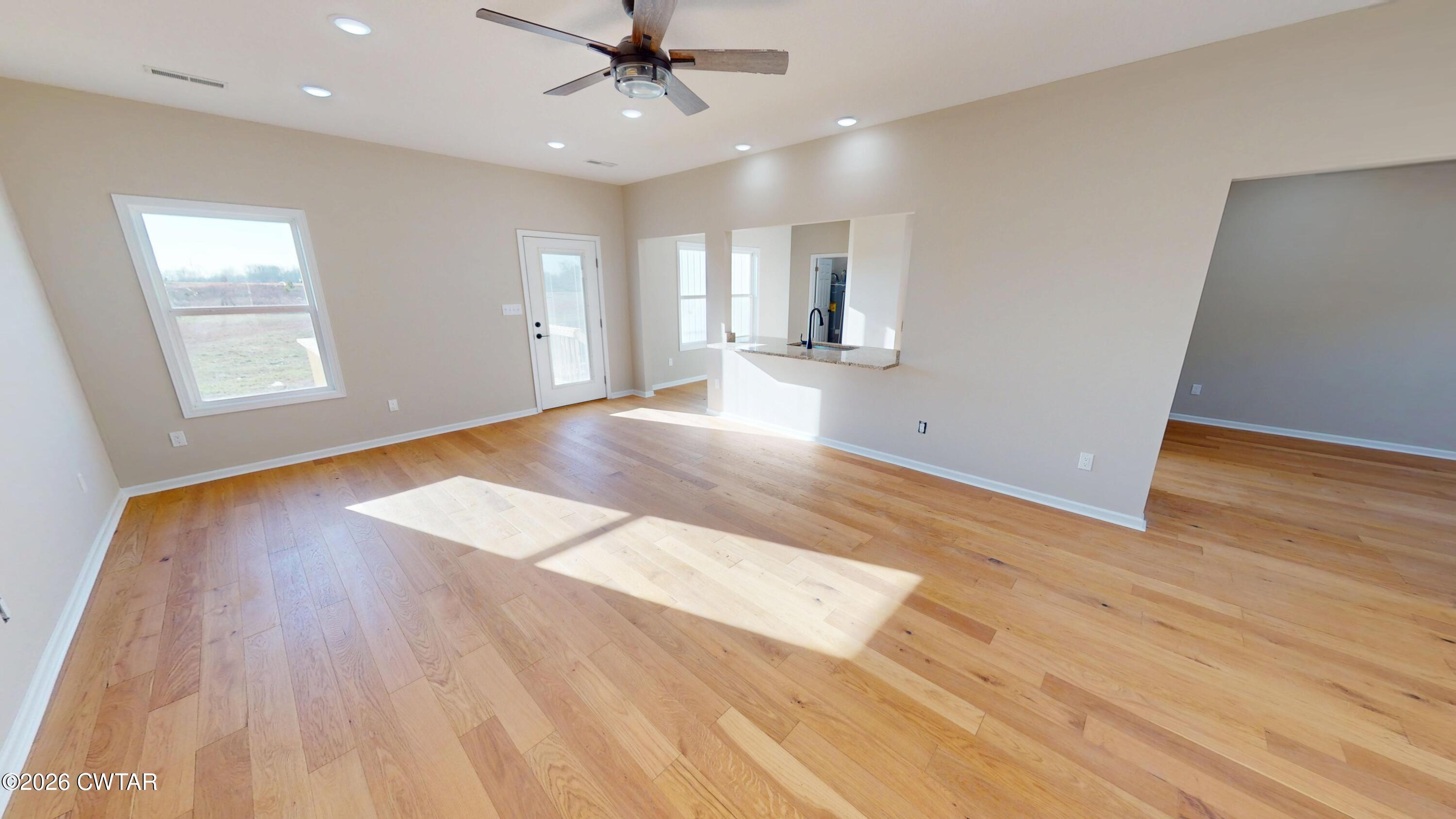 1360 Bonicord Road Dyersburg, TN 38024 - Photo 6 of 31 a view of an empty room with wooden floor and a window
