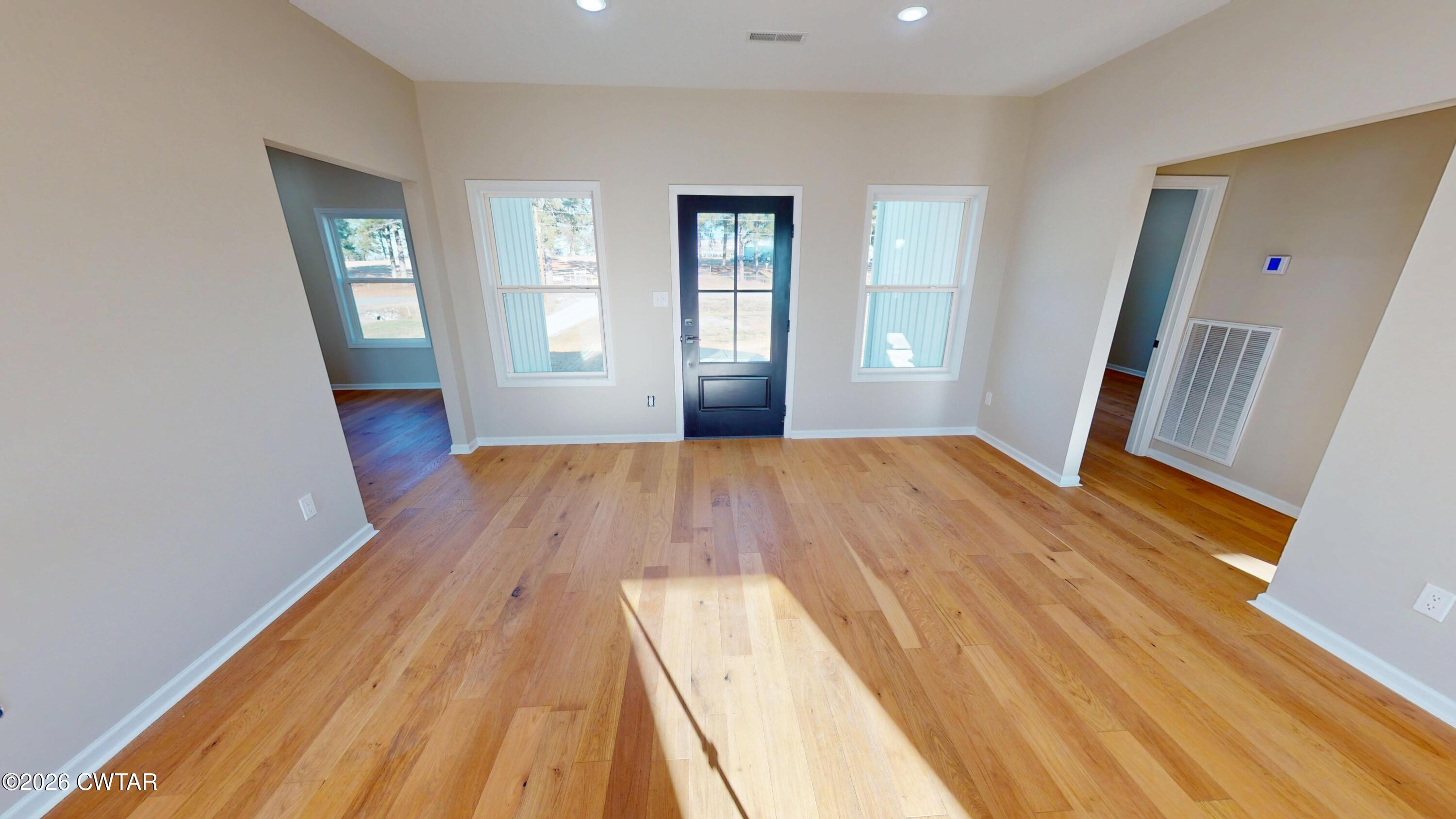 1360 Bonicord Road Dyersburg, TN 38024 - Photo 7 of 31 wooden floor in an empty room with a window