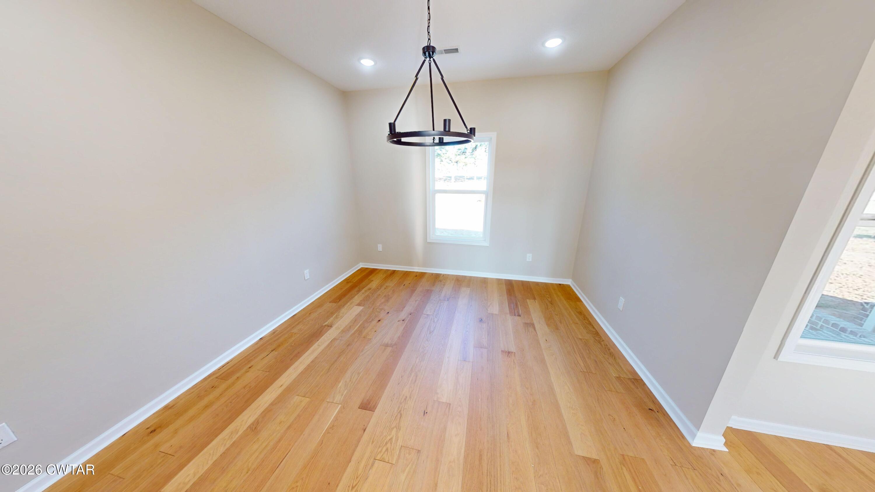 1360 Bonicord Road Dyersburg, TN 38024 - Photo 8 of 31 a view of empty room with wooden floor and windows